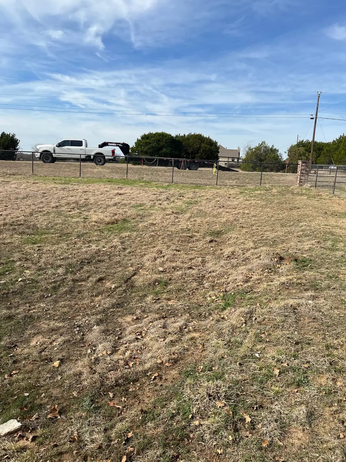 Brush hog mowing along a fence line on a Granbury, TX property