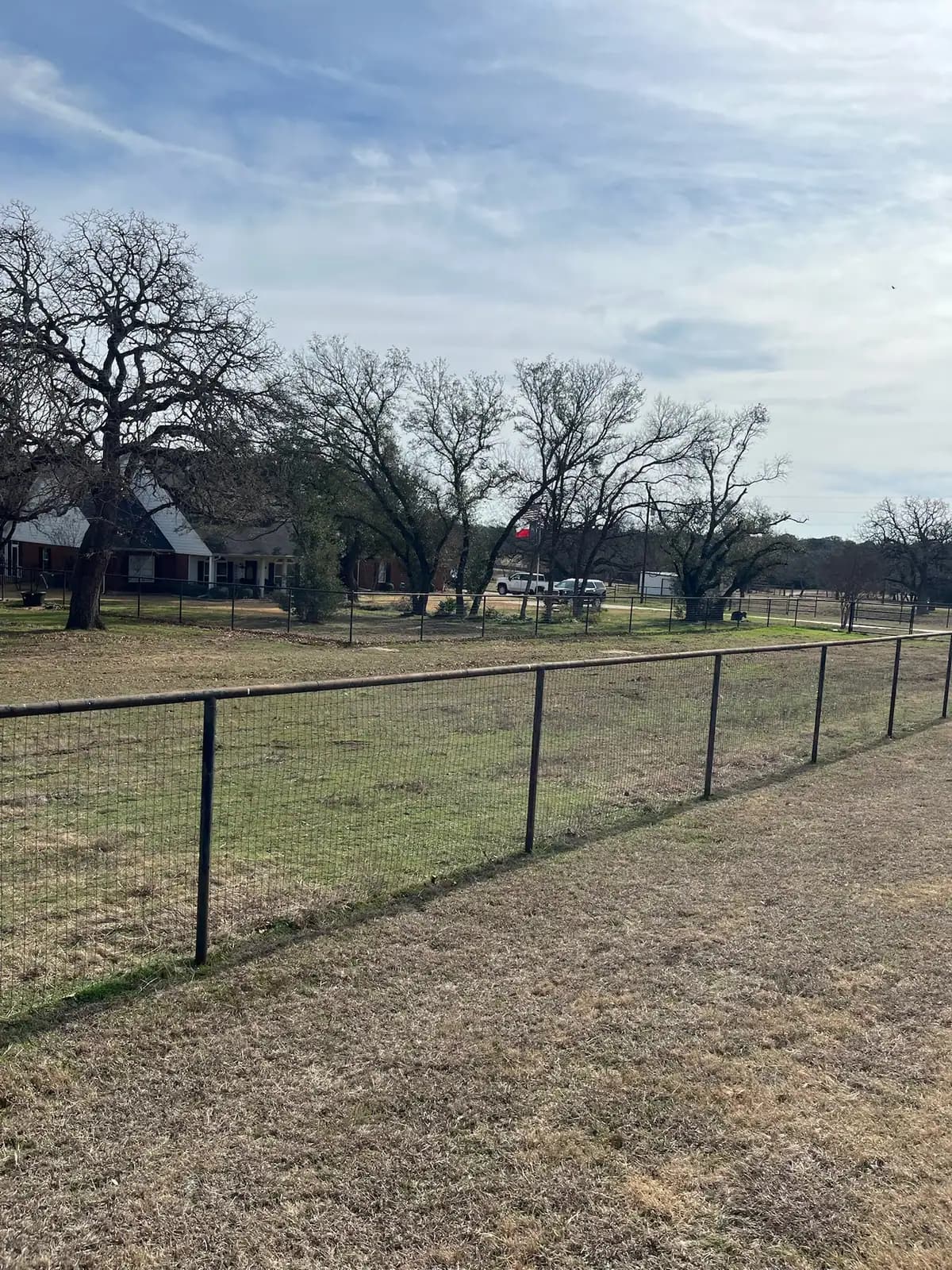 Brush hog mowing along a fence line on a Granbury, TX property