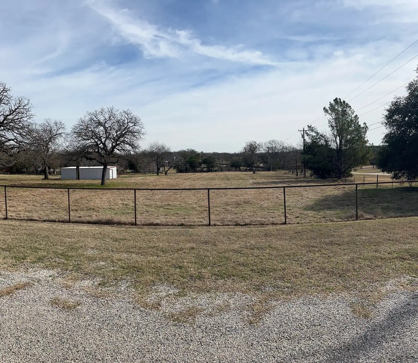 Brush hog mowing along a fence line on a Granbury, TX property
