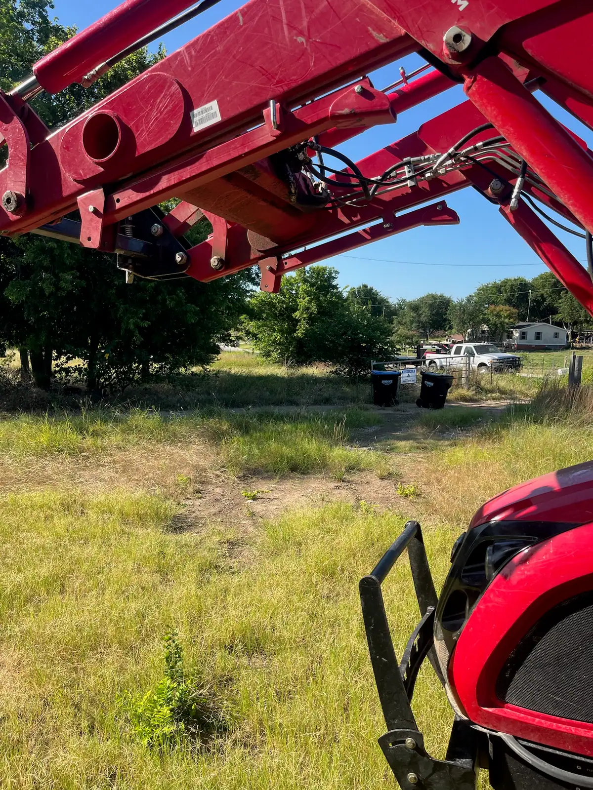 Tall summer grass and weeds before brush hog mowing, seen from the tractor near Granbury, TX