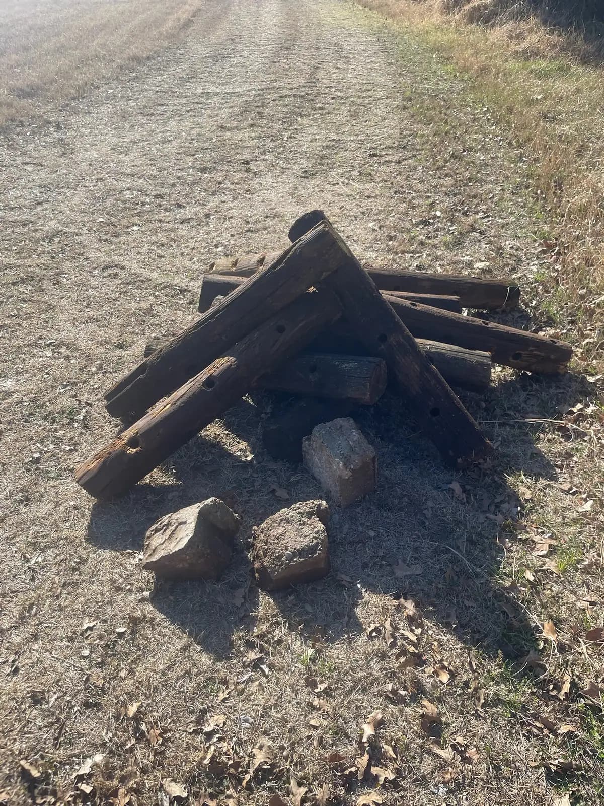 Old fence pipe and posts pulled during land clearing on a Granbury, TX fence line